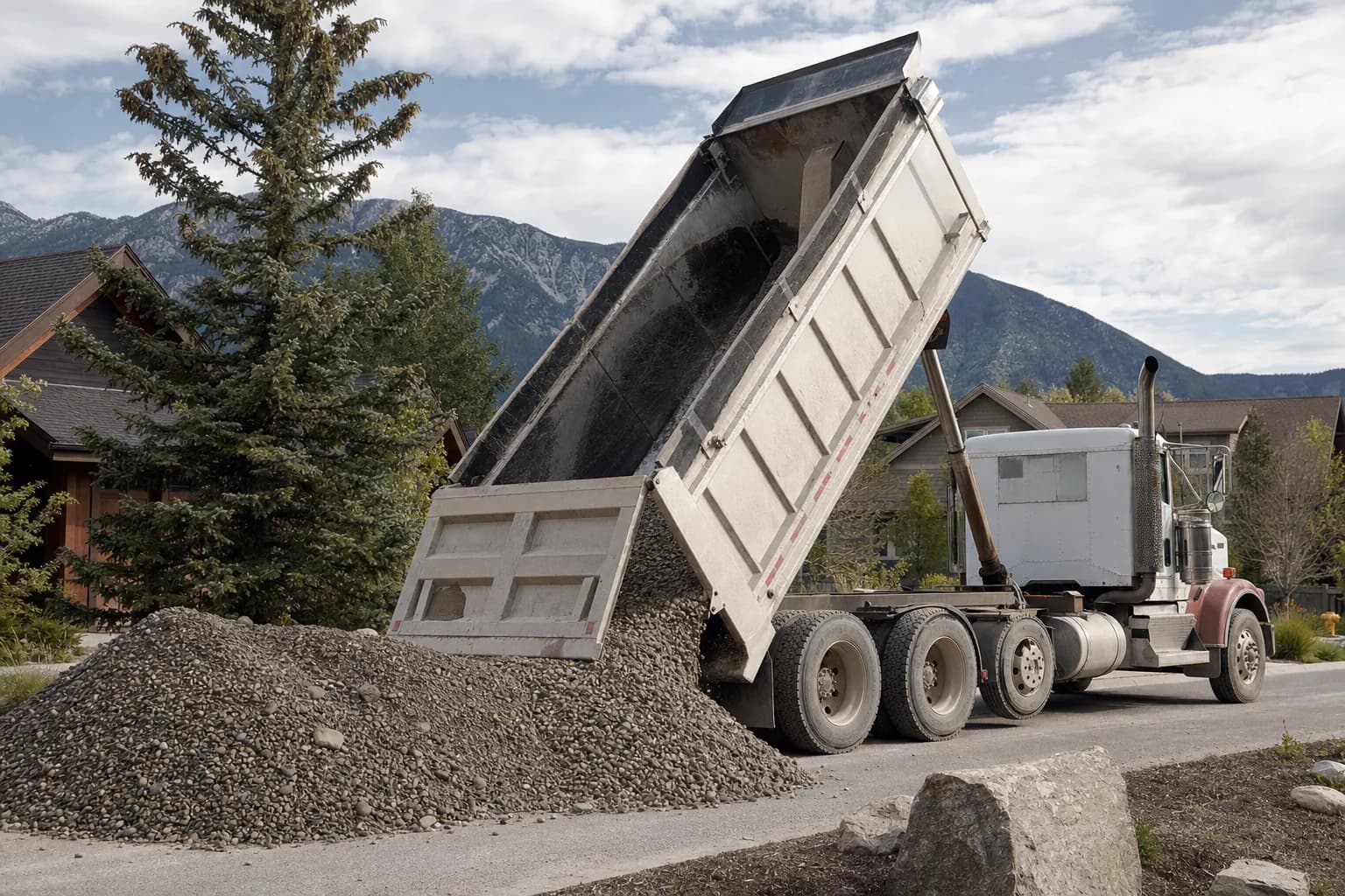 Dump truck delivering gravel